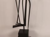 an abstract sculpture of a man and a woman on a black base