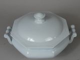 a white dish with a lid on a table