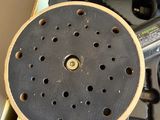 a box with a sanding disc and a sander in it