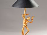 an image of a gold lamp with a black shade on it