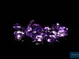 a group of purple gems on a black background