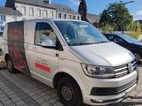 the van is parked on the side of the road in front of a building