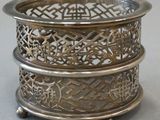 a silver plate with a design on it on a table
