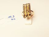 a gold ring that is sitting on top of a piece of paper