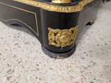 a black and gold clock sitting on top of a table