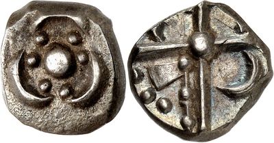 a close up of a coin with a cross on it