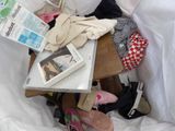 a pile of clothes and shoes sitting on a table