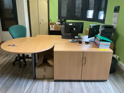 a desk with a chair and a computer on it
