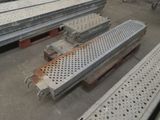 a lot of steel grates sitting on the ground