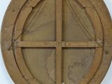 a round window with a wooden frame on the wall