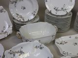 a lot of plates and bowls sitting on a table