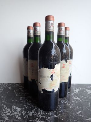 several bottles of wine are lined up on a table