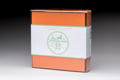 a box of tea sitting on a table with a black background
