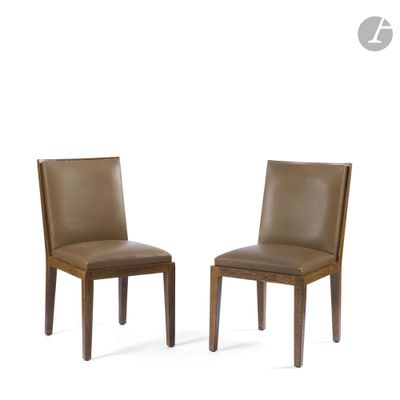 pair of brown leather dining chairs with wooden legs
