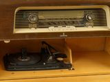 an old radio sitting on top of a wooden cabinet