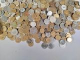 a pile of coins sitting on a white surface