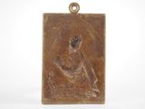 an image of a bronze plaque of a woman holding a baby