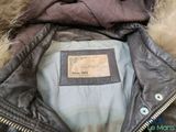 the jacket is brown and has a fur lining around the collar