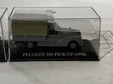 a toy truck in a clear box on a white surface