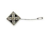 a close up of a diamond broochle on a chain