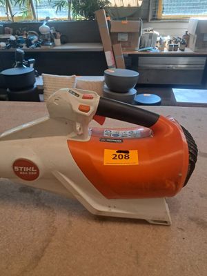 an orange and white electric blower sitting on top of a counter