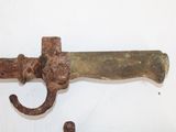 an old rusty knife hanging on a hook