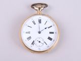 a gold pocket watch with roman numerals on the face
