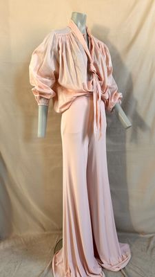 an image of a mannequin wearing a pink dress with a bow