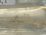 a glass bottle with a label on it sitting on a table