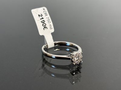 an image of a diamond ring with a price tag on top of it
