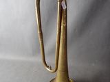 an old brass trumpet sitting on top of a table