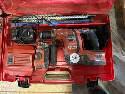 a red tool box with tools in it on a table