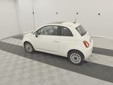 a picture of a small white car parked in a garage