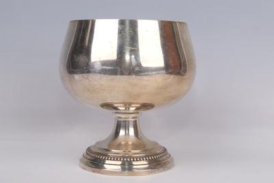a silver goblet sitting on a silver pedestal