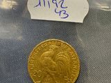 a close up of a gold coin in a plastic bag