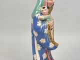 figurine of a woman holding a baby in her arms