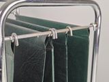 towels hanging on a rack in a bathroom next to a mirror