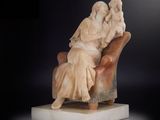 sculpture représentant une femme assise sur une chaise, un enfant sur les genoux