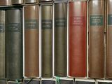 many books that are on a shelf in a library