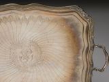 a silver tray with a decorative design on it