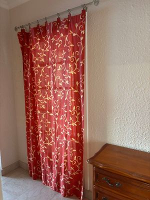 a red curtain hanging in a corner of a room