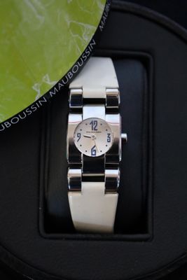 a watch that is sitting on top of a watch stand