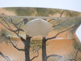 a vase with a tree design on it on a table
