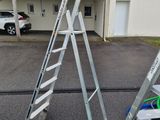 two ladders that are sitting in the parking lot
