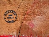 a close up of a piece of wood with red paint on it