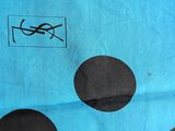 a picture of a blue and black polka dot scarf with a bird on it
