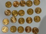 a lot of gold coins sitting on a white surface