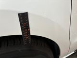 a measuring tape on the side of a white car