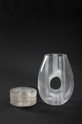 a glass vase and a coin on a black background