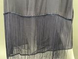 a black and white dress with a black fringe on it